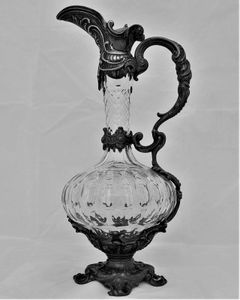French ornate gothic scroll white metal mounted cut glass claret jug antique circa 1870 - shaft & globe shape decorated with thumb cuts & faceted neck 13 inches 1 1/2 pint capacity.