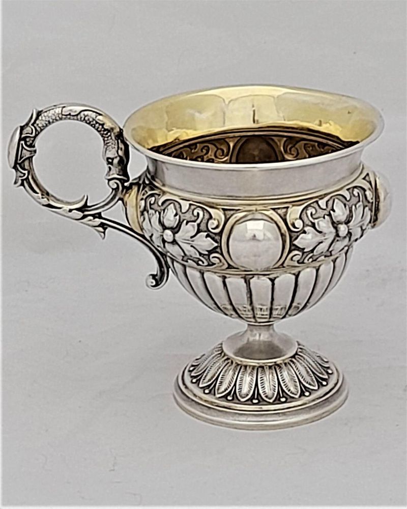 Early 19th century Silver gilt vermiel French Empire style campana shaped cup with ornate floriate repousse decoration sea serpent handle unmarked