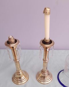 Pair of antique brass spring loaded hurricane candlesticks with grapevine etched glass shades with blue rim & cut glass prism lustre droppers 53 cm High 3.8 kg