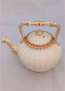 Antique creamware tea kettle shaped teapot with a ribbed  body and opulently gilded in a bachelor size circa 1870