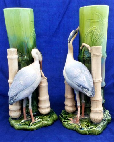 An antique pair of Bretby Art Pottery majolica flower vases or spill holders modelled as bamboo canes each with an oriental crane birds  made by Henry Tooth & Co circa 1895.