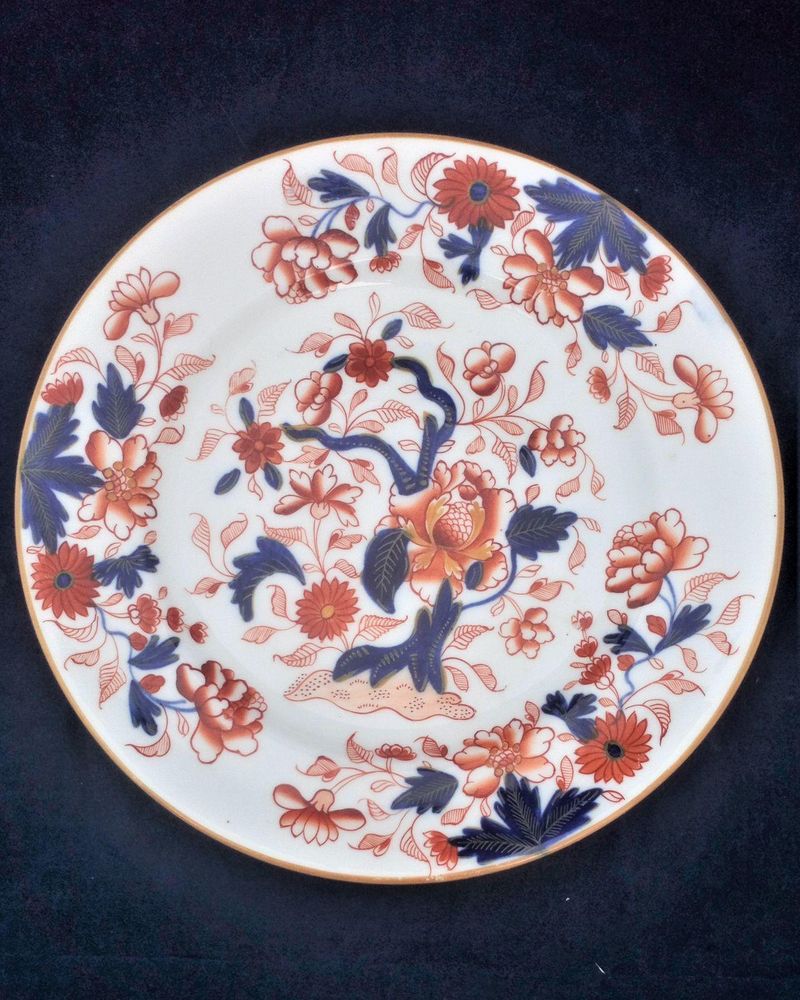 An antique Regency period porcelain 8 inch diameter dessert plate hand painted in an Imari tree Japan pattern early 19th century circa 1815.