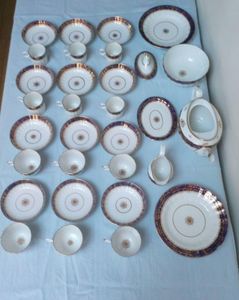 An antique Thomas Grainger Worcester Porcelain tea and coffee service with Hamilton Fluted Tea cups and coffee cans  and fluted new oval shaped teapot decorated with an under glaze blue band with gilded grapevines. Pattern number 195 circa 1810