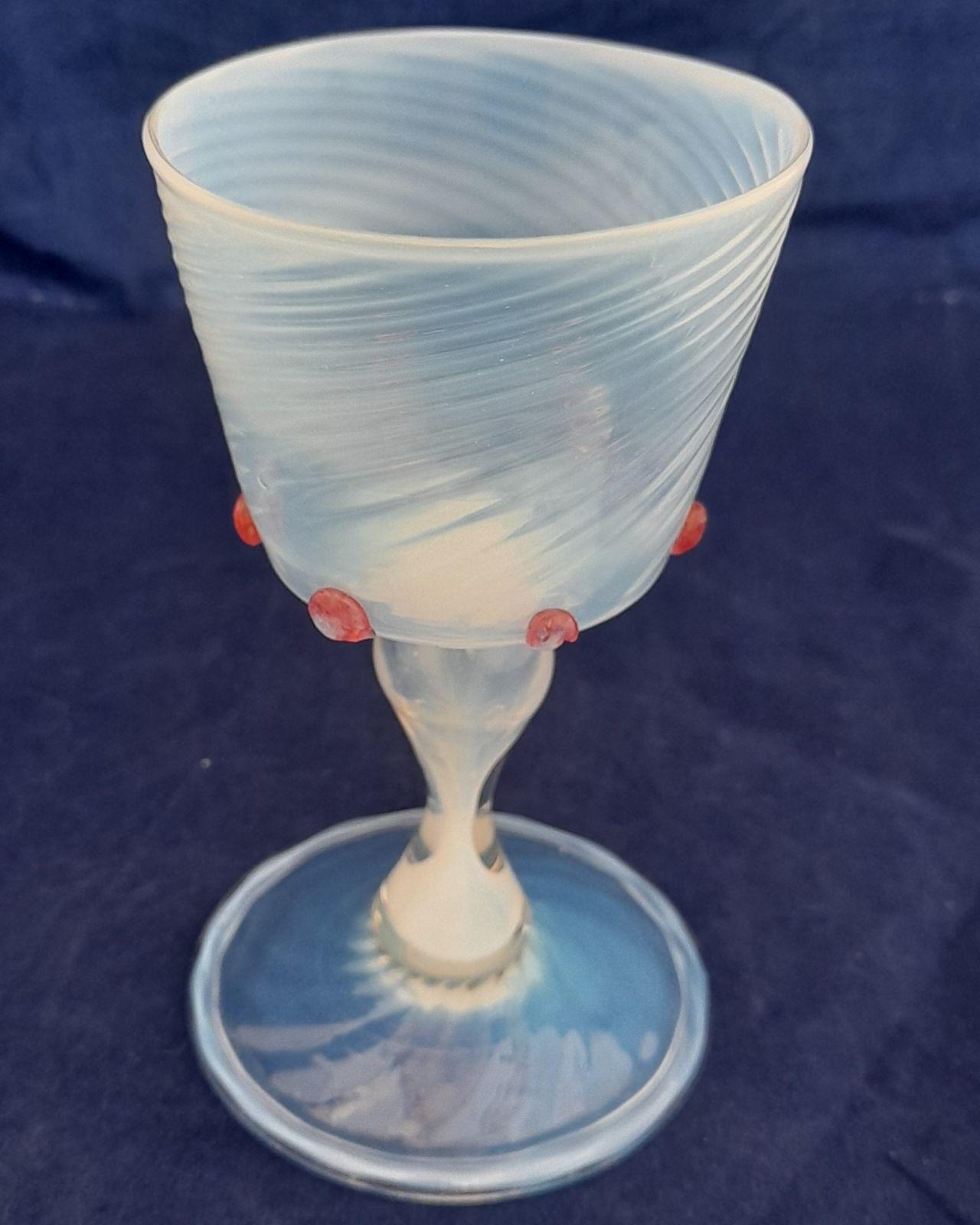 Antique Antonio Salviati & Co Façon de Venise Wrythen Fluted Opal Wine Glass circa 1880.  The wrythen fluted bucket shaped bowl with six applied red prunts, all on a hollow hour glass opal stem, on a wrythen fluted folded foot with a rough pontil. Some typical minor surface wear.