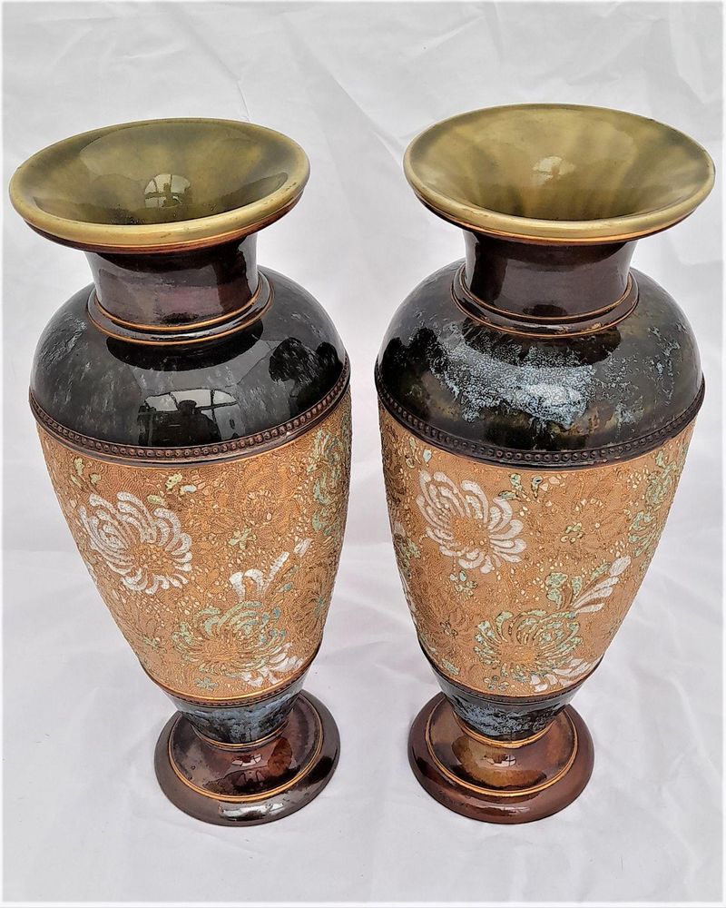 A beautiful pair of antique round baluster shaped Doulton Lambeth stoneware vases decorated with Doulton and Slater's patent technique using  impressed lace fabrics into the wet clay and later gilded and enamelled. 28 cm high total weight 2.242 kg unpacked.