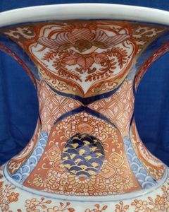 A large, 42.8 cm, Japanese Arita or Imari export porcelain baluster shaped vase with a ribbed body and flared trumpet neck, dating from the Meiji period in the latter half of the 19th century.