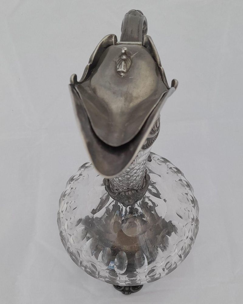 French ornate gothic scroll white metal mounted cut glass claret jug antique circa 1870 - shaft & globe shape decorated with thumb cuts & faceted neck 13 inches 1 1/2 pint capacity.