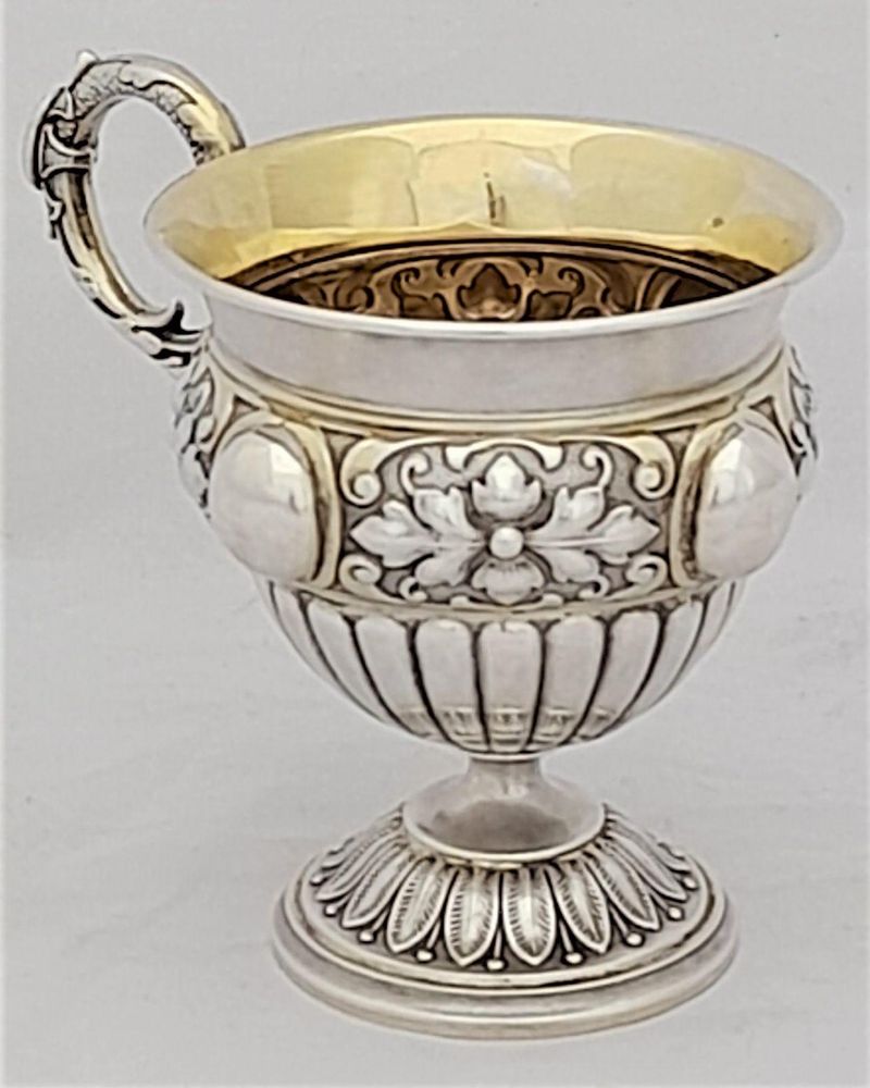 Early 19th century Silver gilt vermiel French Empire style campana shaped cup with ornate floriate repousse decoration sea serpent handle unmarked