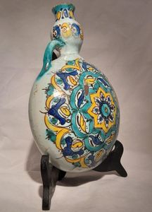 Moroccan tin glazed earthenware or faience pilgrim water flask antique 19th century hand painted with polychrome Arabesque foliate geometric pattern  727 grammes  9 inches long 6.5 inches wide  3 5/8 inches deep