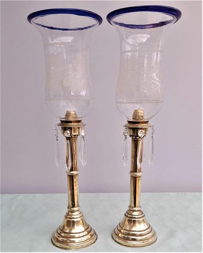 Pair of antique brass spring loaded hurricane candlesticks with grapevine etched glass shades with blue rim & cut glass prism lustre droppers 53 cm High 3.8 kg