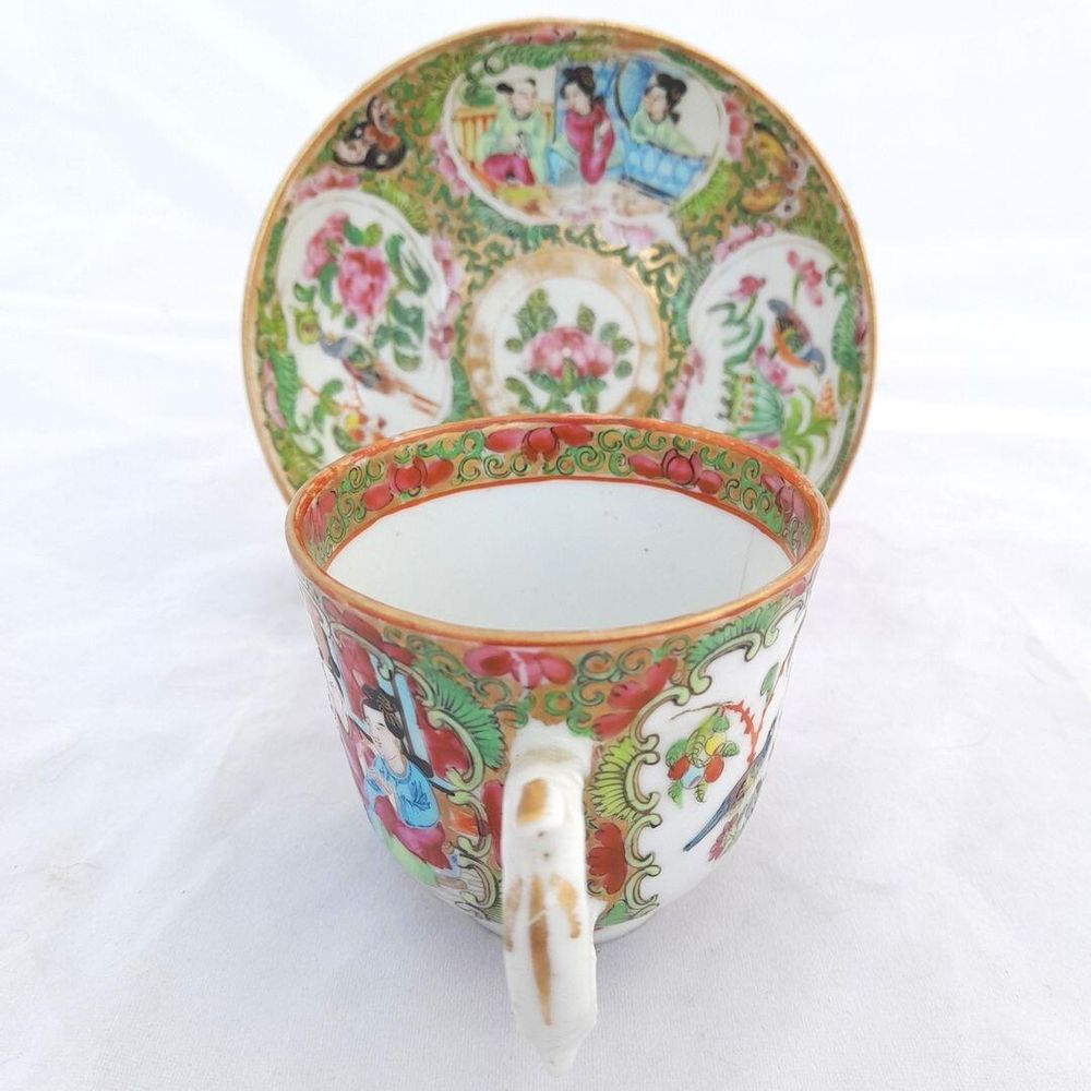 Cup handle first  with saucer on a stand