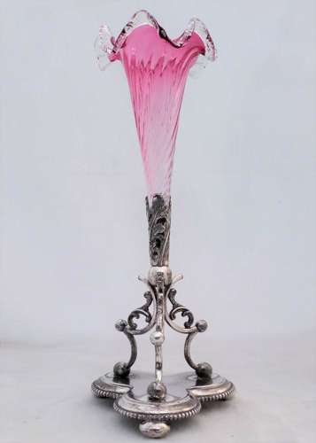 An antique James Deakin and sons silver plated epergne stand with a floriate scroll base and wrythen and frilled ruby glass trumpet circa 1890
