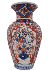 An antique Japanese Imari porcelain vase with a ribbed body hand painted 19th Century Meiji period.