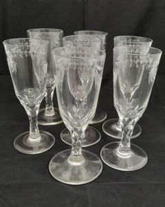 Antique set of seven Georgian style tall round funnel bowl flutes on diamond faceted stems and plain feet. The bowls wheel engraved with OXO and floral swags. Antique Ale Glasses or Champagne Flutes circa 1890