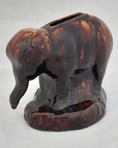 An antique novelty pottery elephant money box with a Rockingham type brown treacle glaze dates to the early 19th century - piggy bank in the form of a Jumbo elephant circa 1830 10. 3 cm high 12.6 cm long