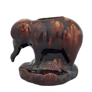 An antique novelty pottery elephant money box with a Rockingham type brown treacle glaze dates to the early 19th century - piggy bank in the form of a Jumbo elephant circa 1830 10. 3 cm high 12.6 cm long