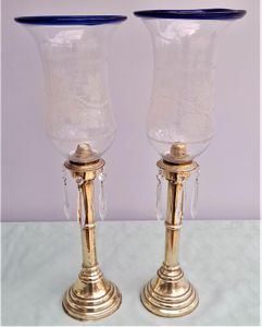 Pair of antique brass spring loaded hurricane candlesticks with grapevine etched glass shades with blue rim & cut glass prism lustre droppers 53 cm High 3.8 kg