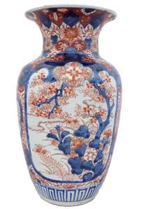 An antique Japanese Imari porcelain vase decorated with hand painted Prunus and rock 30 cm High Meiji late 19th century.