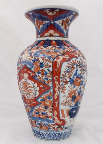An antique Japanese Imari porcelain vase with a ribbed body hand painted 19th Century Meiji period.
