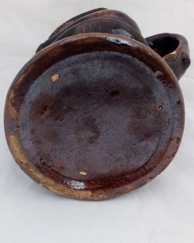 Antique pottery Rockingham brown treacle glazed toby jug known as the Snuff Taker 24 cm high dating from the 19th century circa 1880.