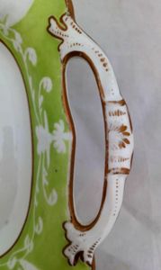 Antique New Hall Porcelain rectangular twin handled dessert dish with low relief rim of birds and fruiting vines on a light green ground. It has a central transfer printed and hand coloured fruit decoration , made in the Georgian period circa 1820 to 1831.
