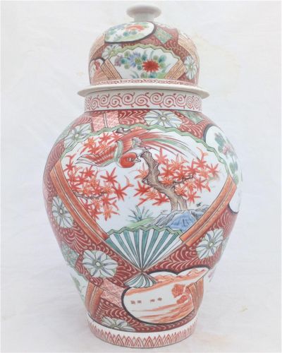 A large antique Japanese Hizen porcelain vase and cover marked Zoshuntei Saiho. Decorated in hand painted enamels with two large Japanese folding fans each painted with a colourful Asiatic Pheasant flying over a Japanese Acer.  This antique temple vase and cover dates from the mid 19th century circa 1860.