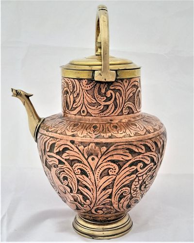 An antique Italian Tuscan repousse copper mezzina water carrier with brass fittings decorated with Cockatrice and acanthus leaf scrolls in an Arts and Crafts style circa 1900