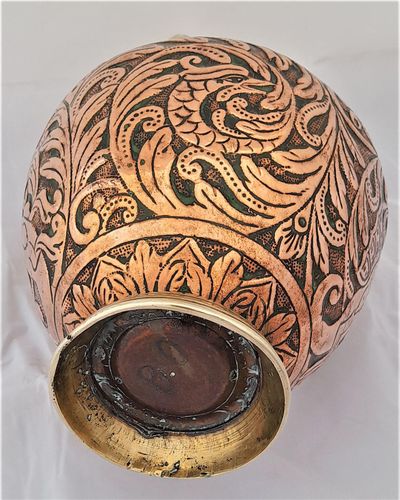 An antique Italian Tuscan repousse copper mezzina water carrier with brass fittings decorated with Cockatrice and acanthus leaf scrolls in an Arts and Crafts style circa 1900