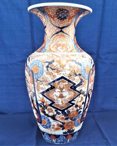 A large, 42.8 cm, Japanese Arita or Imari export porcelain baluster shaped vase with a ribbed body and flared trumpet neck, dating from the Meiji period in the latter half of the 19th century.