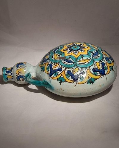 Moroccan tin glazed earthenware or faience pilgrim water flask antique 19th century hand painted with polychrome Arabesque foliate geometric pattern  727 grammes  9 inches long 6.5 inches wide  3 5/8 inches deep