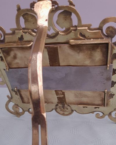 Antique Gothic Revival easel photo picture frame in high relief cast brass - decorated with helmeted leopards, the green man's head & ornate scrolls - for a landscape image size 6" x 4.5" - frame size 9" high, 10 inches wide by 8 inches deep, 19th century circa 1860. weighs 1156 grammes unpacked.
