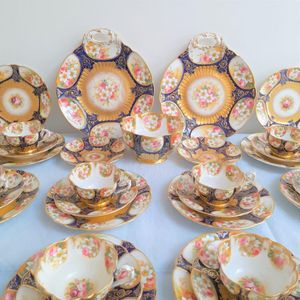 Central close up of the plates, saucers and cups