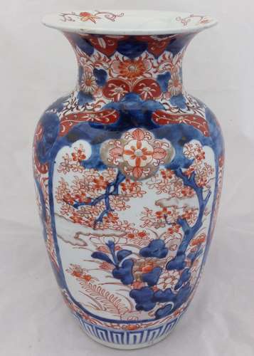 An antique Japanese Imari porcelain vase decorated with hand painted Prunus and rock 30 cm High Meiji late 19th century.