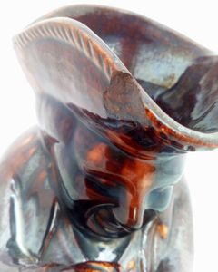 Antique pottery Rockingham brown treacle glazed toby jug known as the Snuff Taker 24 cm high dating from the 19th century circa 1880.