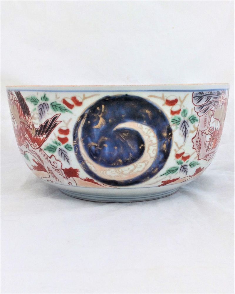 An antique Japanese Arita porcelain bowl or tureen base decorated with hand painted Phoenix feng huang or Ho-Oo birds dating from the Edo period late 18th to early 19th century circa 1800 , 24 cm diameter.