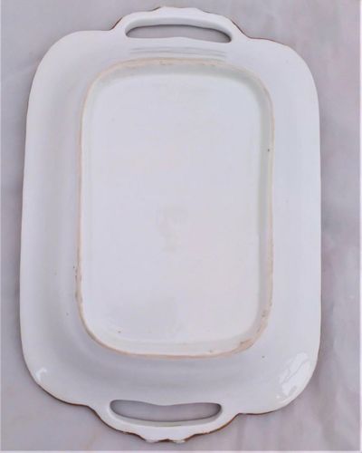 Antique New Hall Porcelain rectangular twin handled dessert dish with low relief rim of birds and fruiting vines on a light green ground. It has a central transfer printed and hand coloured fruit decoration , made in the Georgian period circa 1820 to 1831.
