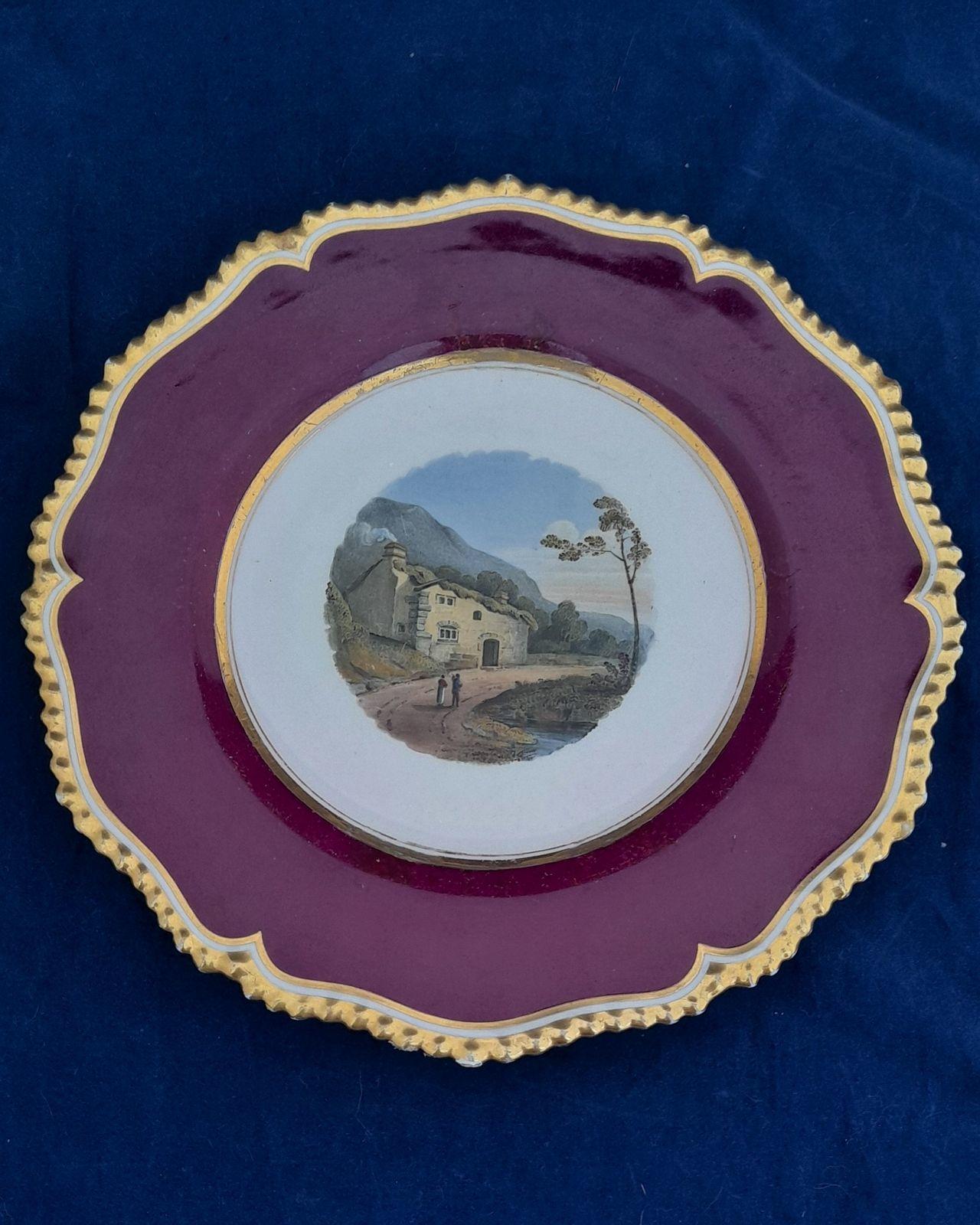 An antique Flight Barr and Barr Worcester Porcelain dessert plate hand painted with a landscape pattern titled Patterdale circa 1825.  The scene is after an oil painting exhibited in the RA in 1783 by Philip James de Loutherbourg  (1740-1812) of a horse and cart outside a cottage in Patterdale, Westmorland. his very fine English porcelain plate carries the impressed mark on the base of a crowned FBB for  Flight,Barr and Barr who operated from 1813 until 1840. The back also has the hand painted mark in puce " Flight Barr and Barr, Royal Porcelain Works, London House No,1 Coventry Street".