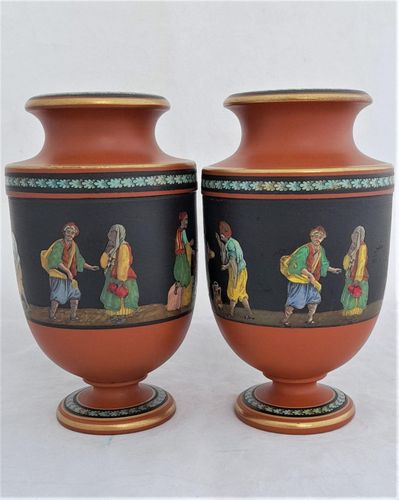 An antique pair of Prattware terracotta Grecian style urn shaped vases, decorated with a hand coloured polychrome enamel monochrome transfer printed pattern which has the name "Turkish Smokers" pattern.  This pattern is attributed to Felix and Richard Pratt, Fenton Potteries, High Street East, Fenton, Stoke on Trent Staffordshire, England. Circa 1860