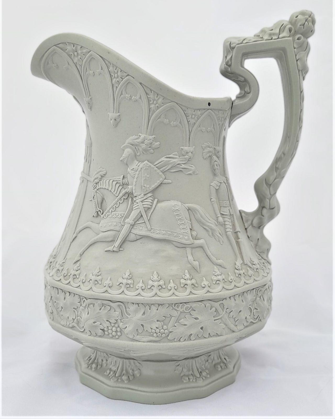 An antique William Ridgway, son and company light sage green stoneware relief moulded jug with the Eglinton Jousting tournament design of jousting knights on horseback and standing figures in armour. First published on 1st September 1840. 19 cm high
