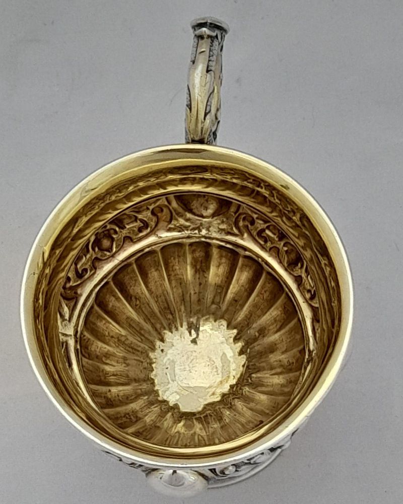 Early 19th century Silver gilt vermiel French Empire style campana shaped cup with ornate floriate repousse decoration sea serpent handle unmarked