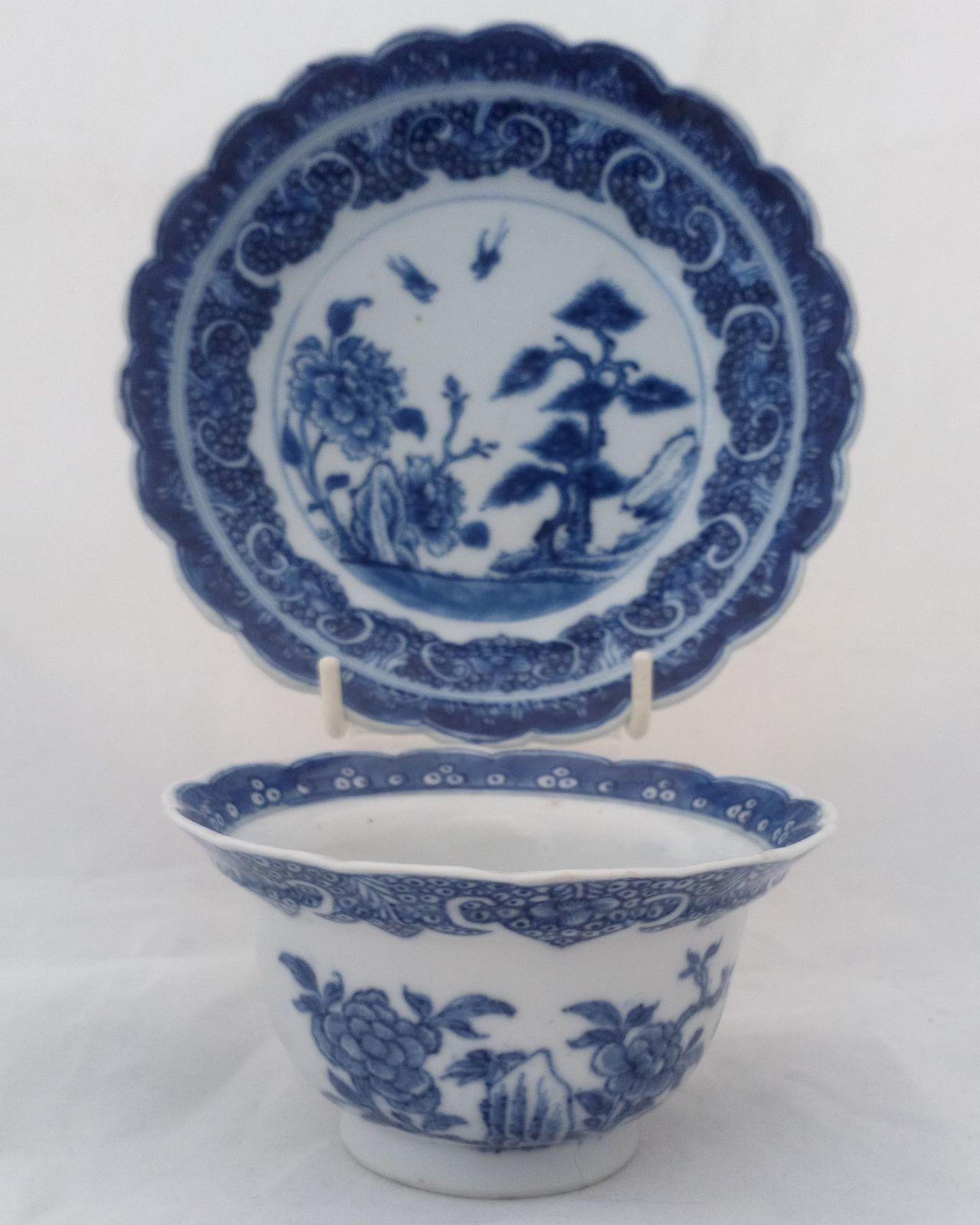 Antique Chinese porcelain hand painted blue and white everted and scalloped rim tea bowl and saucer made during the reign of the Chinese emperor Qianlong 乾隆 during the Qing dynasty circa 1760.