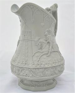 An antique William Ridgway, son and company light sage green stoneware relief moulded jug with the Eglinton Jousting tournament design of jousting knights on horseback and standing figures in armour. First published on 1st September 1840. 19 cm high