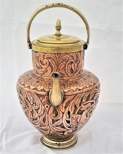 An antique Italian Tuscan repousse copper mezzina water carrier with brass fittings decorated with Cockatrice and acanthus leaf scrolls in an Arts and Crafts style circa 1900