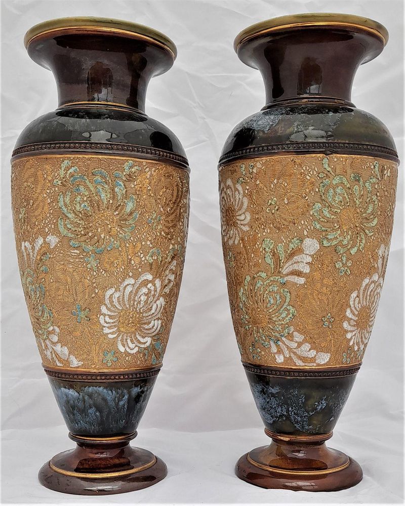 A beautiful pair of antique round baluster shaped Doulton Lambeth stoneware vases decorated with Doulton and Slater's patent technique using  impressed lace fabrics into the wet clay and later gilded and enamelled. 28 cm high total weight 2.242 kg unpacked.