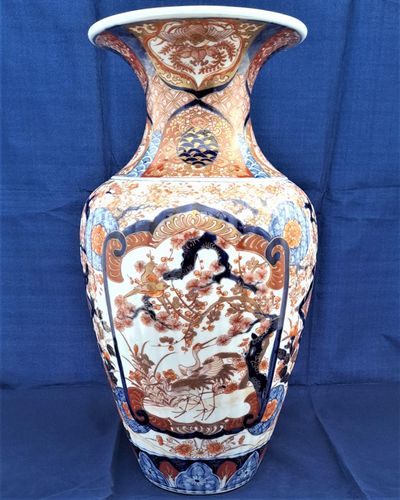 A large, 42.8 cm, Japanese Arita or Imari export porcelain baluster shaped vase with a ribbed body and flared trumpet neck, dating from the Meiji period in the latter half of the 19th century.