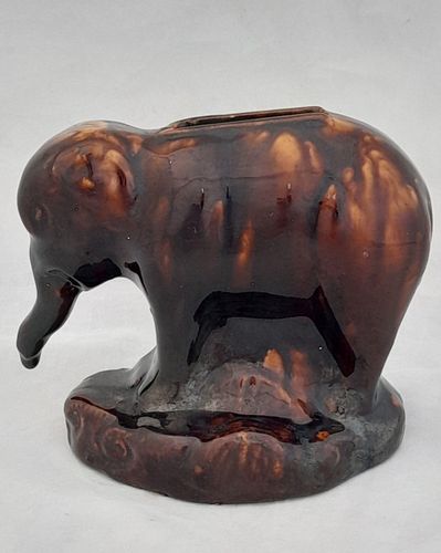 An antique novelty pottery elephant money box with a Rockingham type brown treacle glaze dates to the early 19th century - piggy bank in the form of a Jumbo elephant circa 1830 10. 3 cm high 12.6 cm long