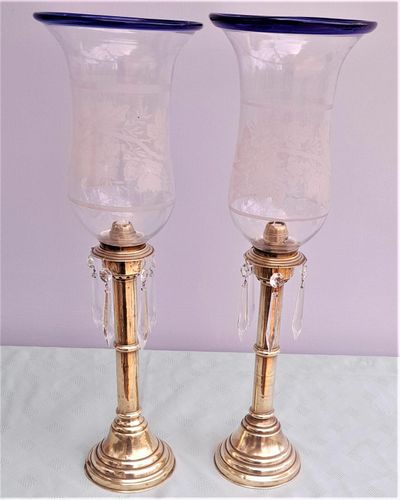 Pair of antique brass spring loaded hurricane candlesticks with grapevine etched glass shades with blue rim & cut glass prism lustre droppers 53 cm High 3.8 kg