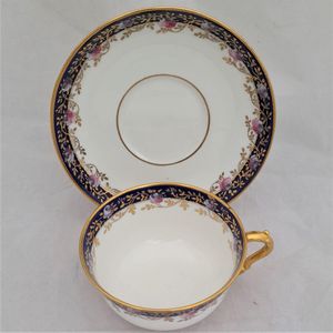 top of cup  - Antique porcelain tea cup & saucer hand painted blue rim & swagged pink roses by W. Lambert 1915 - Larcombe King St Derby on a Bishop & Stonier Blank