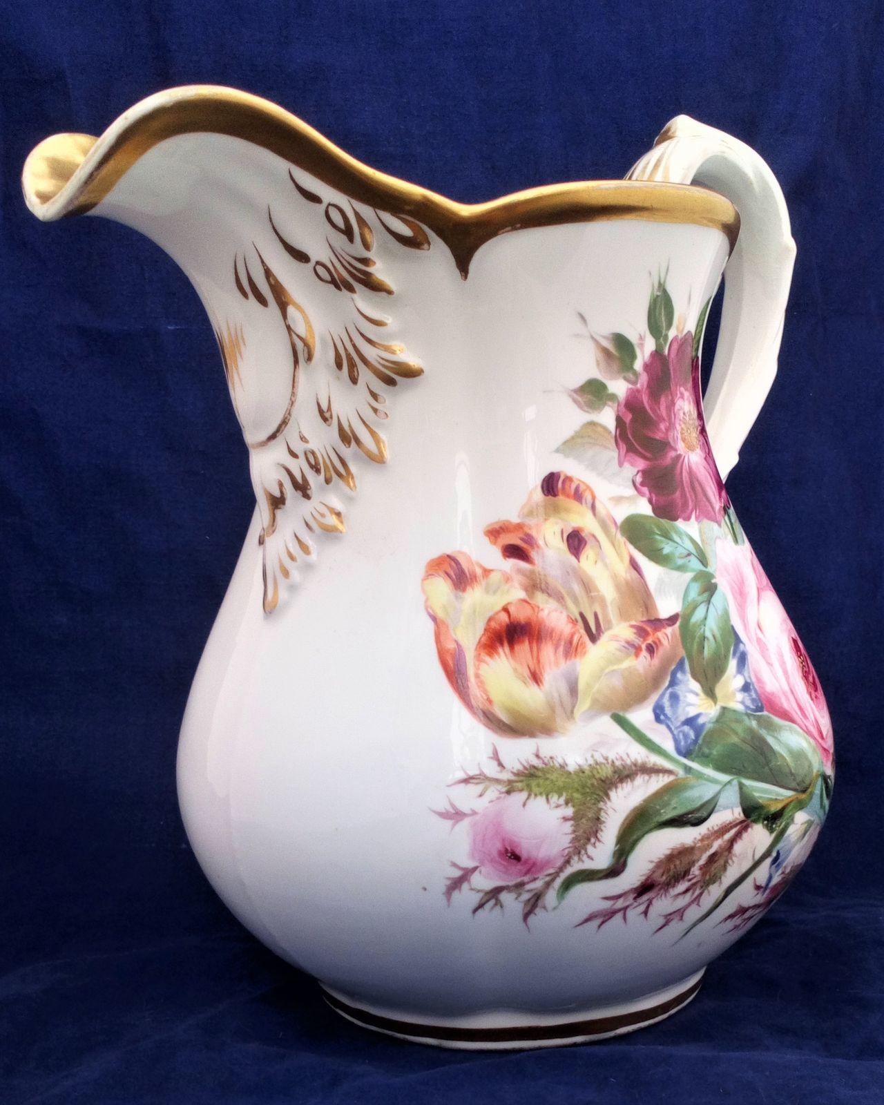 A large antique five pint capacity porcelain jug made by John Rose of  Coalport probably painted by William Billingsley with Flowers circa 1825. It is 10 inches high.
