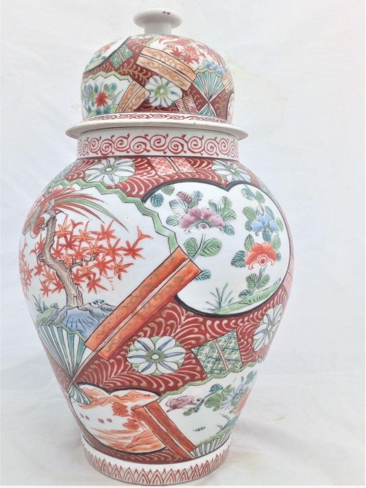 A large antique Japanese Hizen porcelain vase and cover marked Zoshuntei Saiho. Decorated in hand painted enamels with two large Japanese folding fans each painted with a colourful Asiatic Pheasant flying over a Japanese Acer.  This antique temple vase and cover dates from the mid 19th century circa 1860.